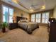 Inviting main bedroom features tray ceilings, neutral carpeting, plantation shutters, and ample natural light at 511 Bonneset Ct, Canton, GA 30114