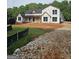 New construction home featuring black windows, covered porch, and wood details at 95 Cambridge, Covington, GA 30014