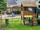 Backyard view of a playhouse with swings at 350 Lakeview Dr, Brooks, GA 30205