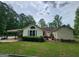 Exterior home with a partially damaged deck and tidy backyard and trees at 350 Lakeview Dr, Brooks, GA 30205