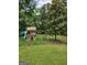 Backyard view of a playhouse with slide and swings at 350 Lakeview Dr, Brooks, GA 30205
