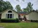 Exterior home with a partially damaged deck and tidy backyard and trees at 350 Lakeview Dr, Brooks, GA 30205