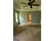 Bright bedroom with large window and view of a bathroom featuring tile and white fixtures at 350 Lakeview Dr, Brooks, GA 30205