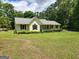 Charming single-story home with a well-manicured lawn and mature landscaping at 350 Lakeview Dr, Brooks, GA 30205
