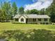 Charming single-story home with a well-manicured lawn and mature landscaping at 350 Lakeview Dr, Brooks, GA 30205