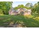 Exterior view of a pink house featuring a spacious backyard and a swing set at 4333 Deer Ridge Ct, Lilburn, GA 30047