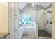 Modern bathroom with a soaking tub, glass shower, and ample storage at 4333 Deer Ridge Ct, Lilburn, GA 30047