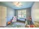 bedroom is equipped with playful decor, toys, and ample natural light with a view to the outdoors at 4333 Deer Ridge Ct, Lilburn, GA 30047
