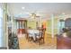 Well-lit dining room featuring hardwood floors, fireplace, access to other living spaces and backyard at 4333 Deer Ridge Ct, Lilburn, GA 30047