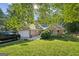 Inviting brick home featuring an attached garage, green lawn, mature trees, and a large driveway at 4333 Deer Ridge Ct, Lilburn, GA 30047