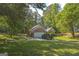 Charming brick home with attached garage and large driveway, surrounded by lush greenery and mature trees at 4333 Deer Ridge Ct, Lilburn, GA 30047