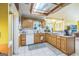 Functional kitchen with light wood cabinetry, white appliances, tile countertops, and ample natural light at 4333 Deer Ridge Ct, Lilburn, GA 30047