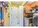Well-equipped laundry room includes a modern washer, shelving, and practical storage solutions at 4333 Deer Ridge Ct, Lilburn, GA 30047