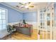 Bright home office with a large desk, wainscoting, hardwood floors, and plenty of natural light at 4333 Deer Ridge Ct, Lilburn, GA 30047