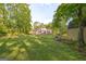 The rear of the home with a large backyard and storage shed nestled among the trees at 4333 Deer Ridge Ct, Lilburn, GA 30047