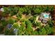 Expansive aerial view of a lushly wooded property with a home, barn, pond, and swimming pools at 3313 Henson Ln, Stockbridge, GA 30281