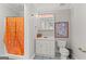 Bright bathroom with blue tile flooring, a white vanity, and a shower featuring a colorful shower curtain at 3313 Henson Ln, Stockbridge, GA 30281
