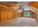 This spacious bonus room is a flexible space with wood paneled walls, metal ceiling, and natural light at 3313 Henson Ln, Stockbridge, GA 30281