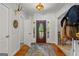Bright foyer with decorative rug, and wooden door creating a warm and stylish entryway at 3313 Henson Ln, Stockbridge, GA 30281