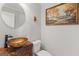 Stylish half bathroom with decorative sink, wood vanity, and unique wall decor at 3313 Henson Ln, Stockbridge, GA 30281