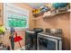 Functional laundry room with a modern washer and dryer, plus built-in shelving at 3313 Henson Ln, Stockbridge, GA 30281