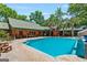 Inviting pool area with seating, a covered patio, and lush trees providing shade and privacy at 3313 Henson Ln, Stockbridge, GA 30281