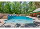 Beautiful pool area with a slide, surrounded by seating and lush landscaping, perfect for relaxation at 3313 Henson Ln, Stockbridge, GA 30281
