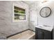 Updated bathroom features tub, vanity, window, and tiled shower walls at 765 Shellnut Dr, Forest Park, GA 30297