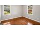 Bedroom with hardwood floors, base molding, and two windows overlooking the backyard at 765 Shellnut Dr, Forest Park, GA 30297