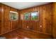 This bedroom features warm wood paneling and two windows offering ample natural light at 765 Shellnut Dr, Forest Park, GA 30297