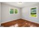 Empty bedroom featuring two windows and beautiful wood floors at 765 Shellnut Dr, Forest Park, GA 30297