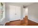 Empty bedroom featuring hardwood floors, a large closet, and a window at 765 Shellnut Dr, Forest Park, GA 30297