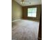 Bedroom with plush carpeting, ceiling fan, and a bright window at 201 Summerford Pl, Stockbridge, GA 30281