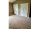 Bedroom featuring neutral walls, carpeted floors, and double-door closets at 201 Summerford Pl, Stockbridge, GA 30281