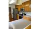 Light-filled kitchen with stainless steel appliances and wooden cabinets overlooking dining area at 201 Summerford Pl, Stockbridge, GA 30281