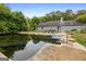 Backyard with a large in-ground pool surrounded by mature trees at 2804 Davis Mill N Rd, Dallas, GA 30157