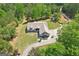 Aerial view of the home and its expansive landscaped grounds and long private driveway at 411 Johnson Rd, Locust Grove, GA 30248