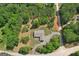 Aerial view of the home surrounded by beautiful, mature trees and a long private driveway at 411 Johnson Rd, Locust Grove, GA 30248