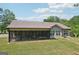 The backyard features a large screened-in porch, well maintained lawn, and mature trees at 411 Johnson Rd, Locust Grove, GA 30248