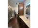 The bathroom offers a vanity with wood cabinets, a white countertop, and a mirror with storage at 411 Johnson Rd, Locust Grove, GA 30248