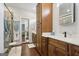 Bathroom featuring double sinks, storage cabinets, and a glass enclosed shower at 411 Johnson Rd, Locust Grove, GA 30248