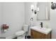 Bathroom featuring a wooden vanity, toilet and a mirror at 411 Johnson Rd, Locust Grove, GA 30248