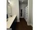Bathroom offers dark wood cabinets, a white counter, and a shower with patterned curtain at 411 Johnson Rd, Locust Grove, GA 30248
