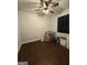 Bedroom with hardwood floors, a ceiling fan, and a window with dark blinds at 411 Johnson Rd, Locust Grove, GA 30248