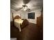Bedroom with wood floors, a ceiling fan, large windows, and traditional furnishings at 411 Johnson Rd, Locust Grove, GA 30248