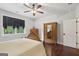 Bedroom with hardwood floors, large bed and a window that brings in natural light at 411 Johnson Rd, Locust Grove, GA 30248