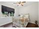 Bedroom with hardwood floors, window and a brass bed at 411 Johnson Rd, Locust Grove, GA 30248