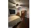 A cozy bedroom is furnished with a bed, antique dresser, wardrobe, and ceiling fan at 411 Johnson Rd, Locust Grove, GA 30248