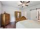 Bedroom with hardwood floors, large bed and a window that brings in natural light at 411 Johnson Rd, Locust Grove, GA 30248