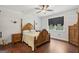 Bedroom with hardwood floors, large bed and a window that brings in natural light at 411 Johnson Rd, Locust Grove, GA 30248